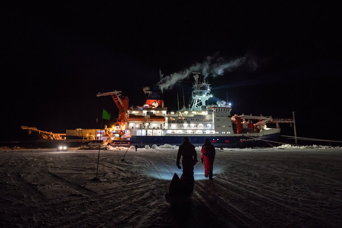  The illuminated Polarstern in the darkness of the Arctic ice during the MOSAiC expedition. 